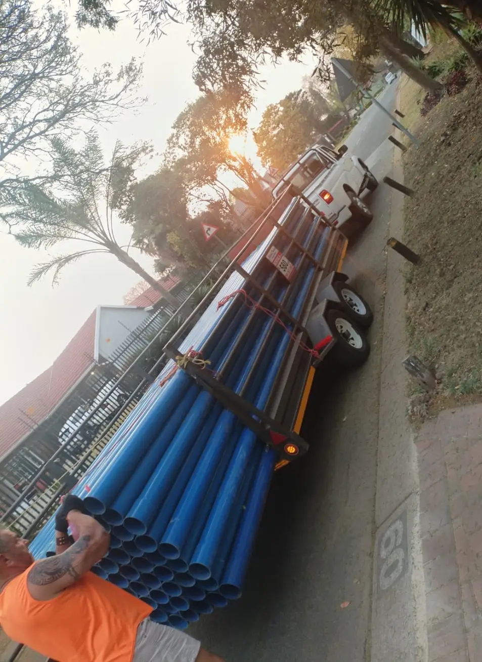 Trailer loaded with blue PVC borehole casing pipes